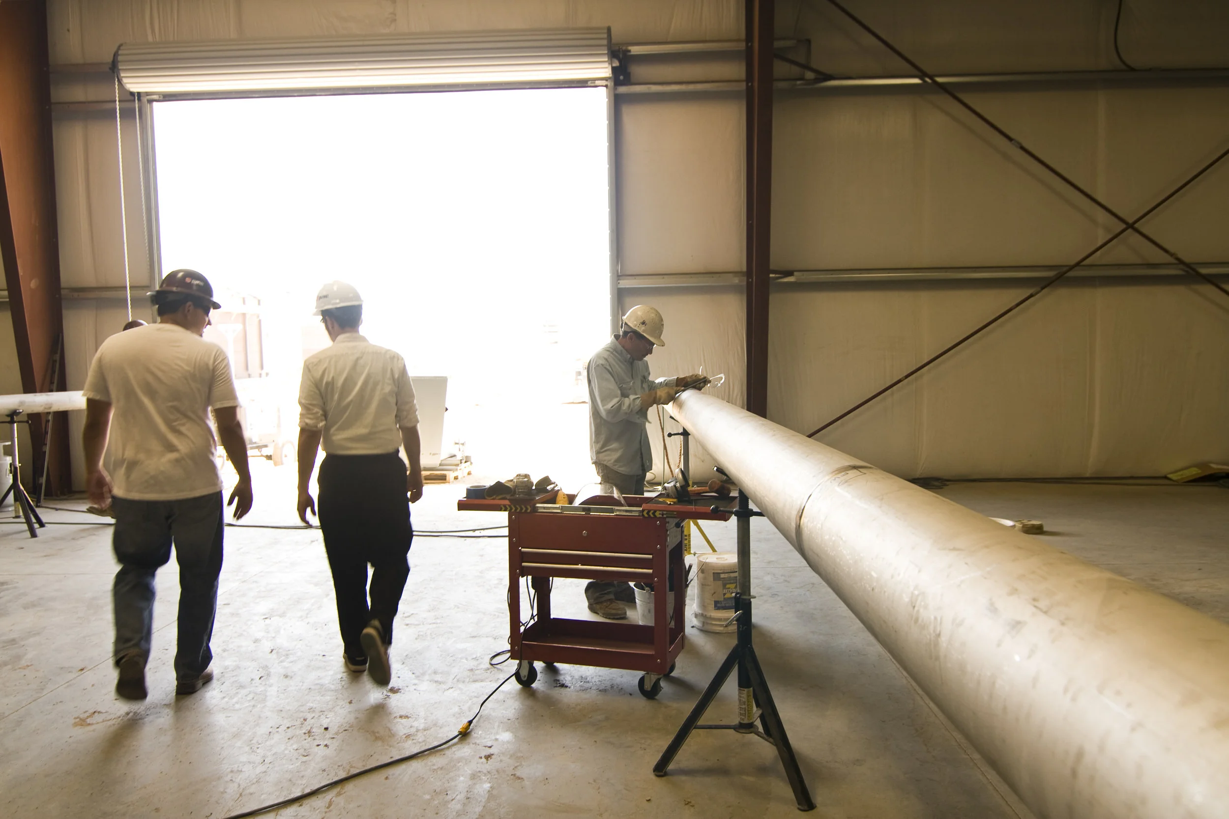 Large doors bring lots of sun into the space. In this back part of the warehouse, workers fabricate specialty pipes.