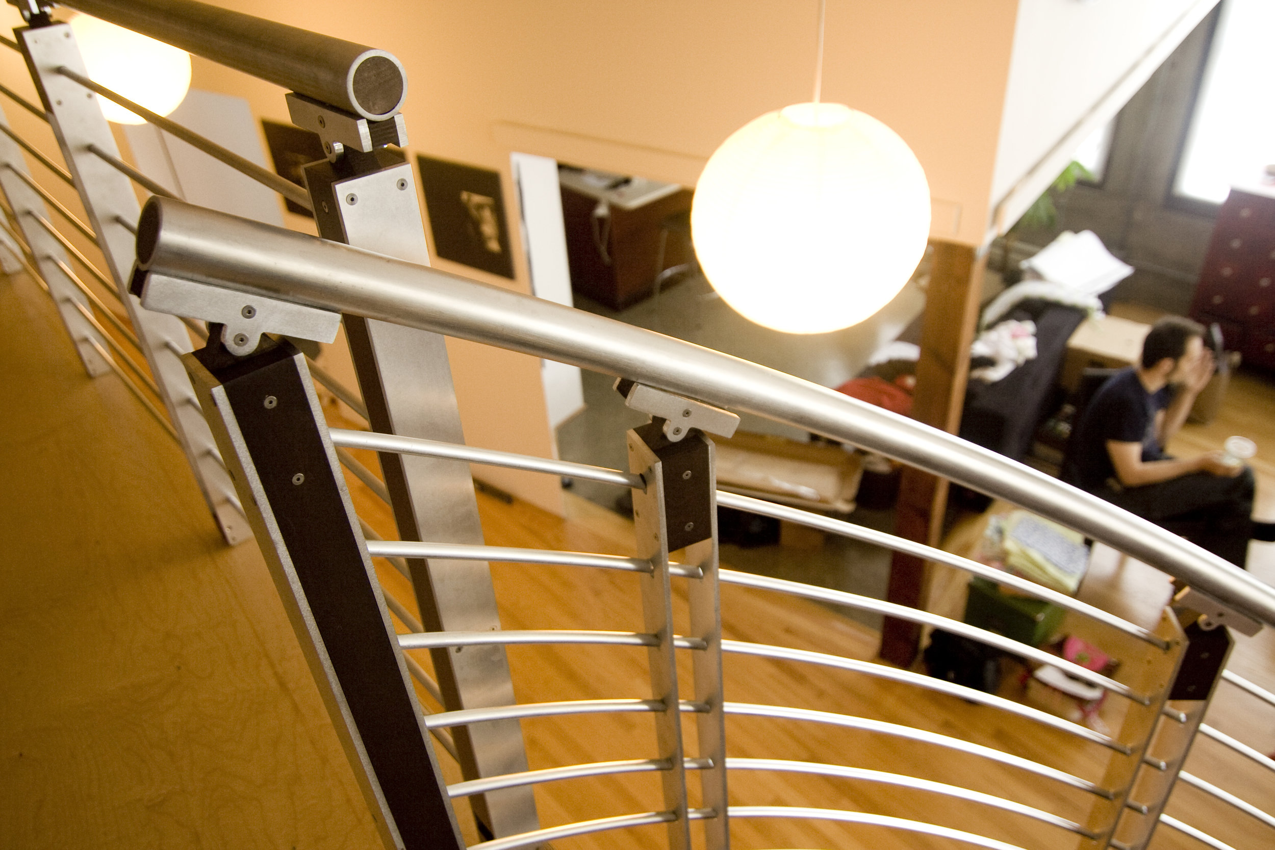  The playful almost-intersecting railings at the top of the stairs add a fun interest. 