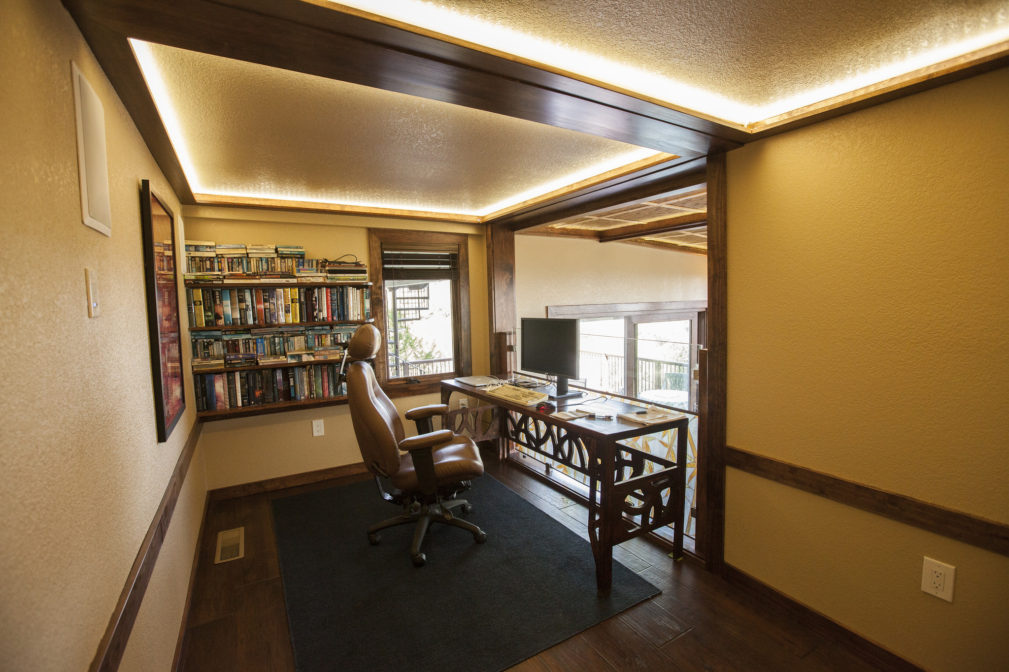  The office is redone with the same recessed thatch selling, new wood flooring and fun new desk. 