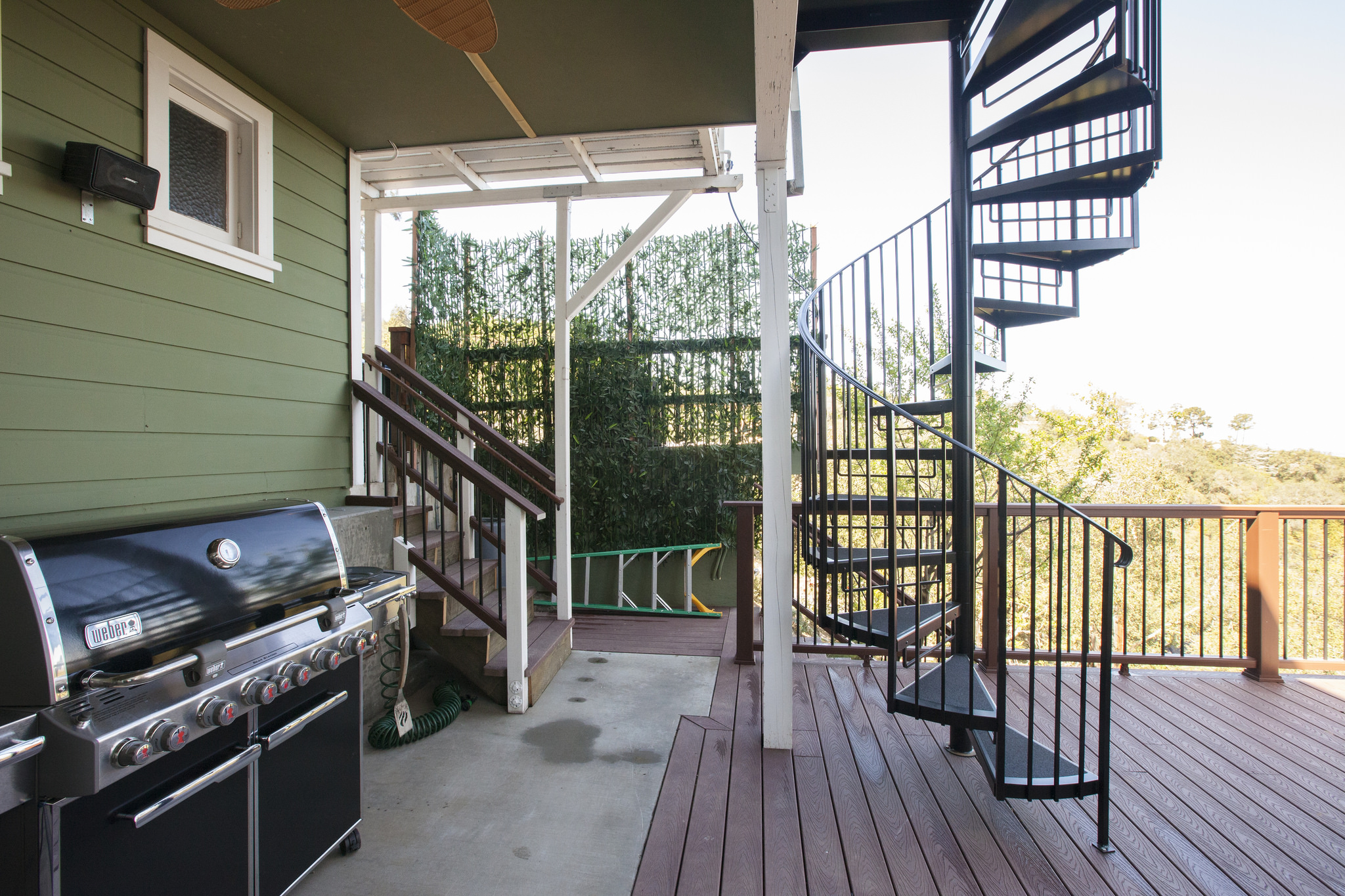  A new spiral staircase connects the upstairs to the outside deck, and the new outside kitchen makes this deck a wonderfully usable space. 