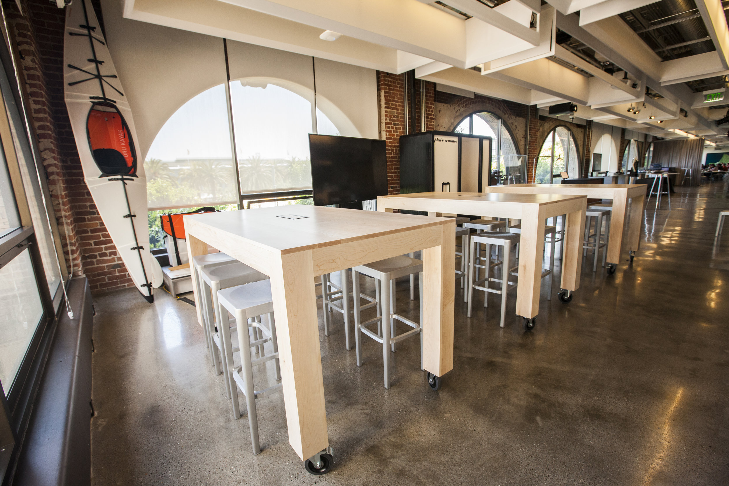  Large maple hardwood tables, made to be durable and highly functional for gallery classes and presentations. These tables at The Autodesk Gallery in San Francisco are standing height, have locking caster wheels and center power units. 