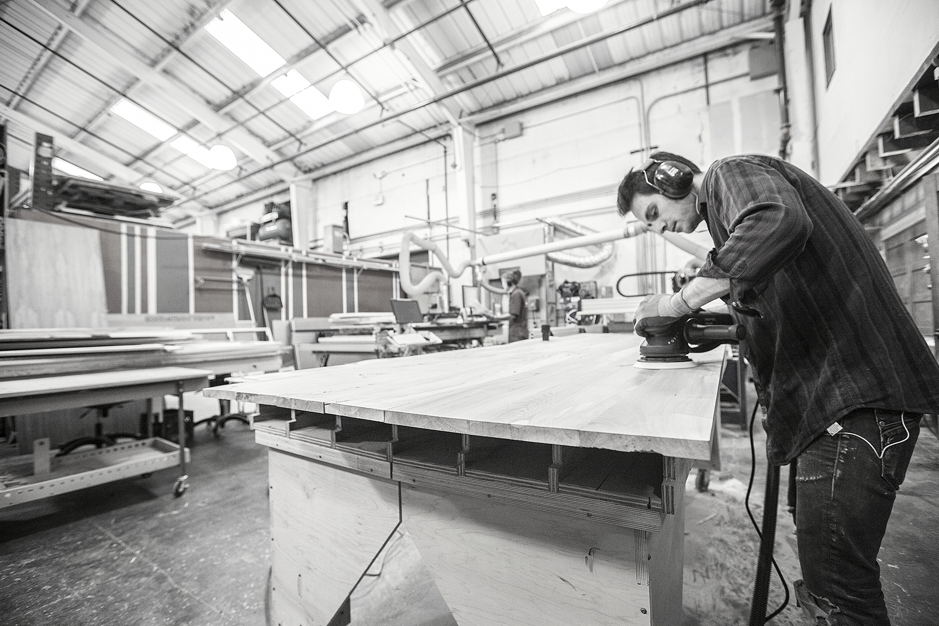  Joel in the shop, milling, joining and finish sanding the sycamore before the final assembly. 