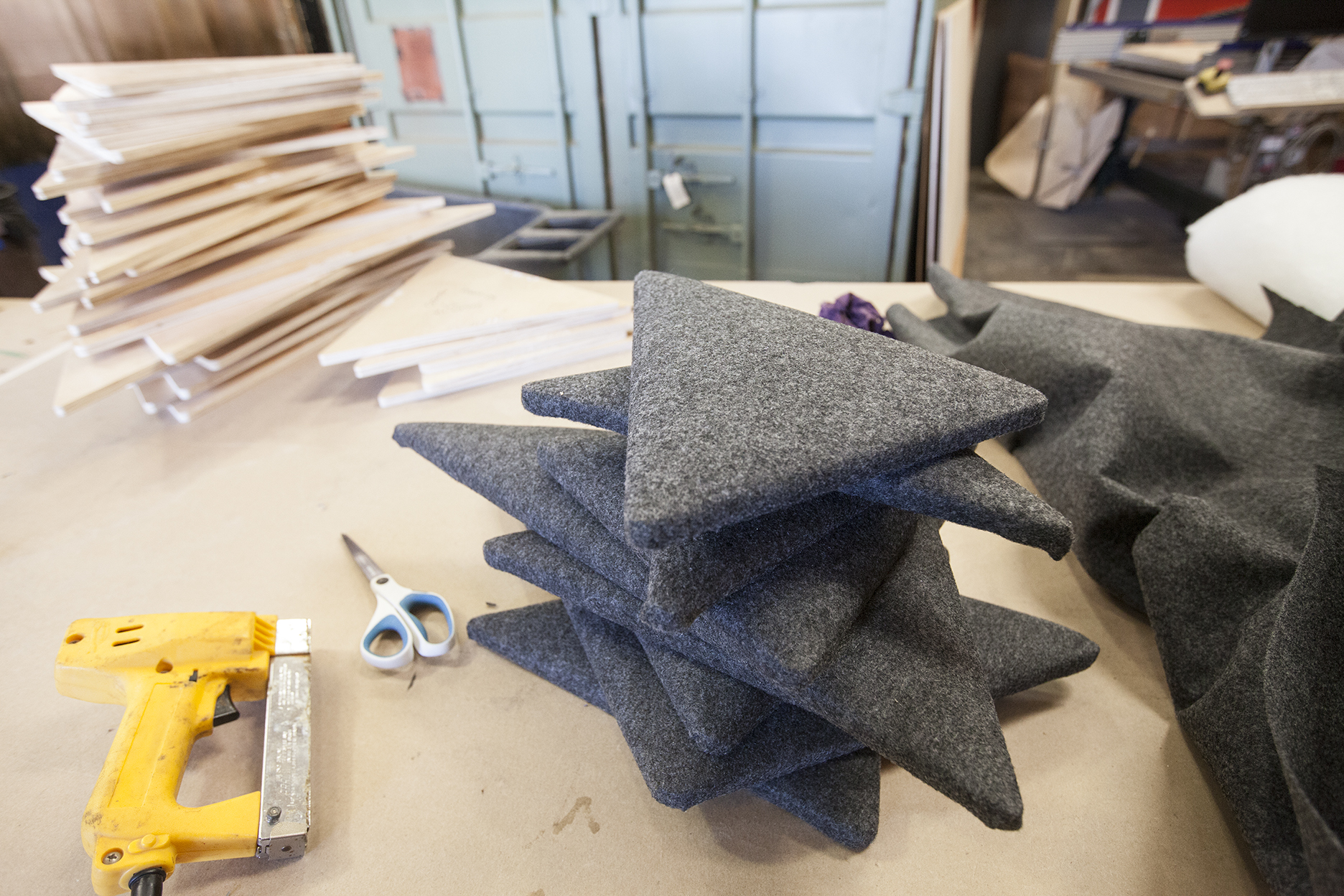  A pile of soft grey felt panels ready for client approval. 