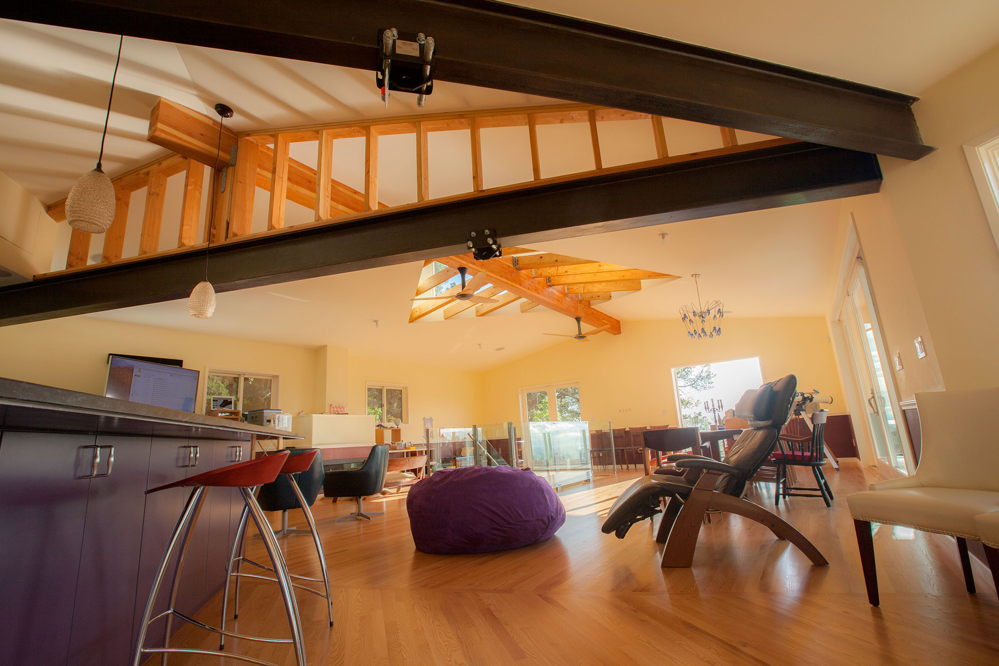 The interior, now with a grand open kitchen, living and dining room is filled with light and has easy access to the front deck and backyard.