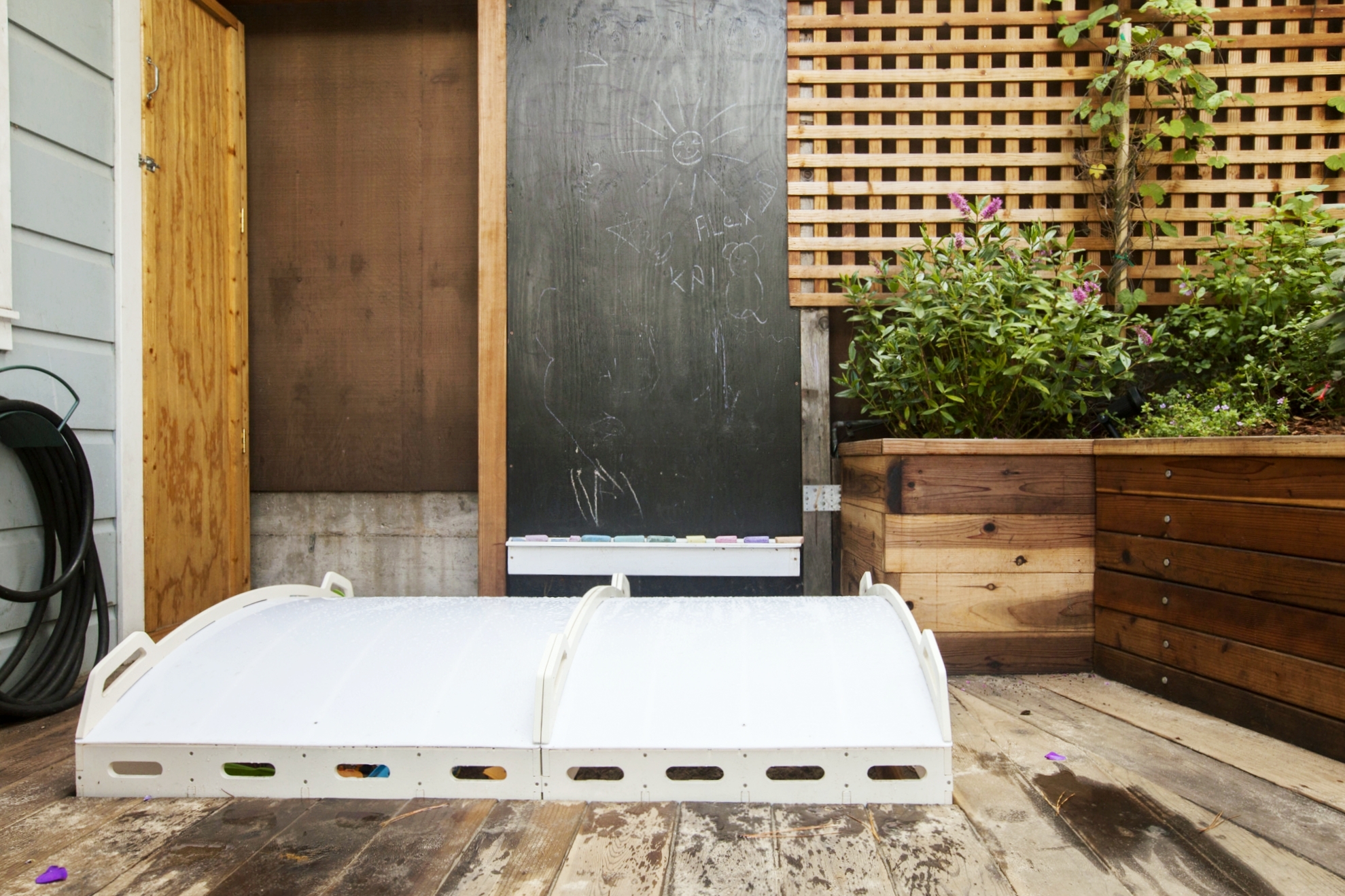  Going outside to the back yard, we designed an easy to use sandbox cover, for kid safety, and to keep the cats and rain out. 