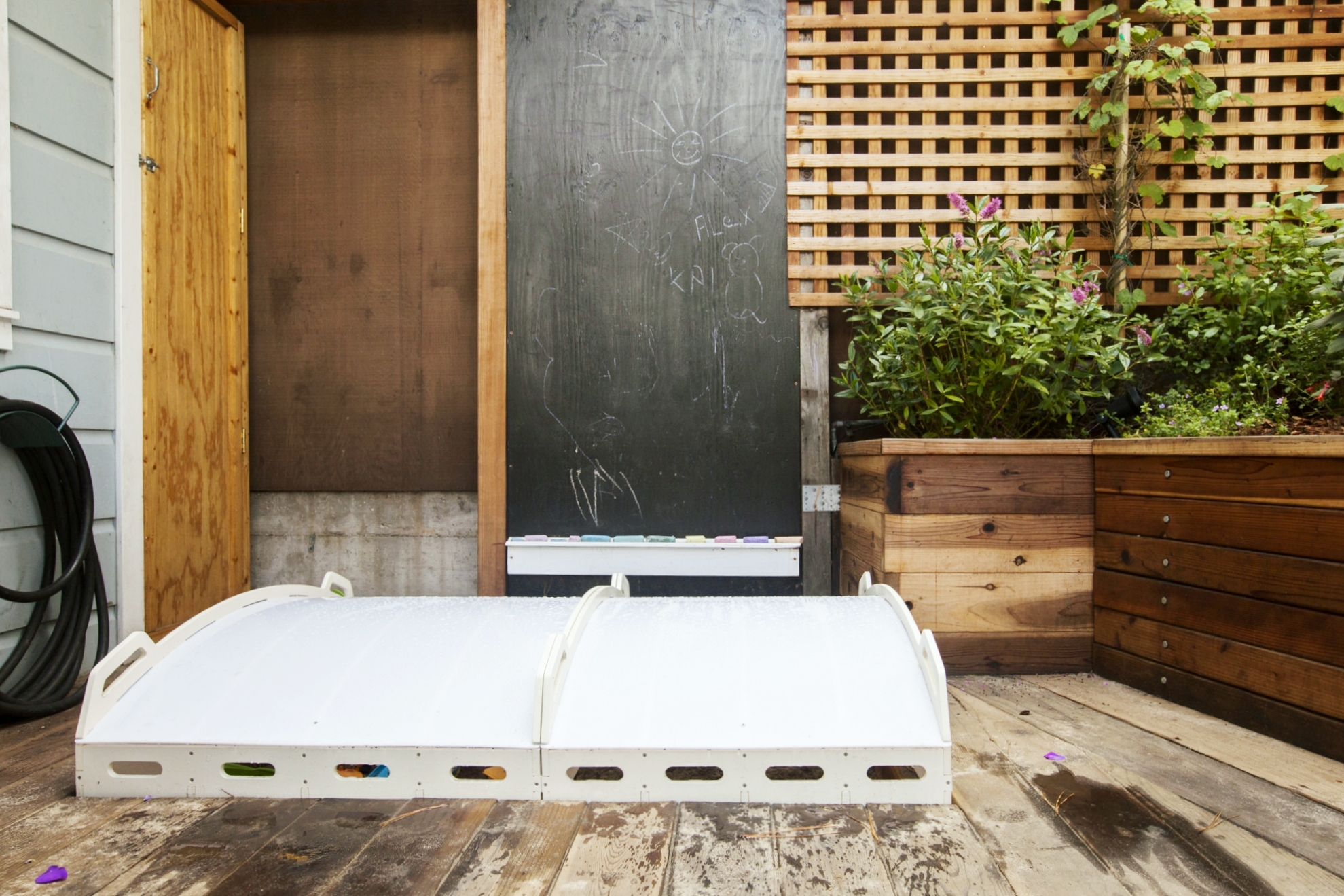 Going outside to the back yard, we designed an easy to use sandbox cover, for kid safety, and to keep the cats and rain out.