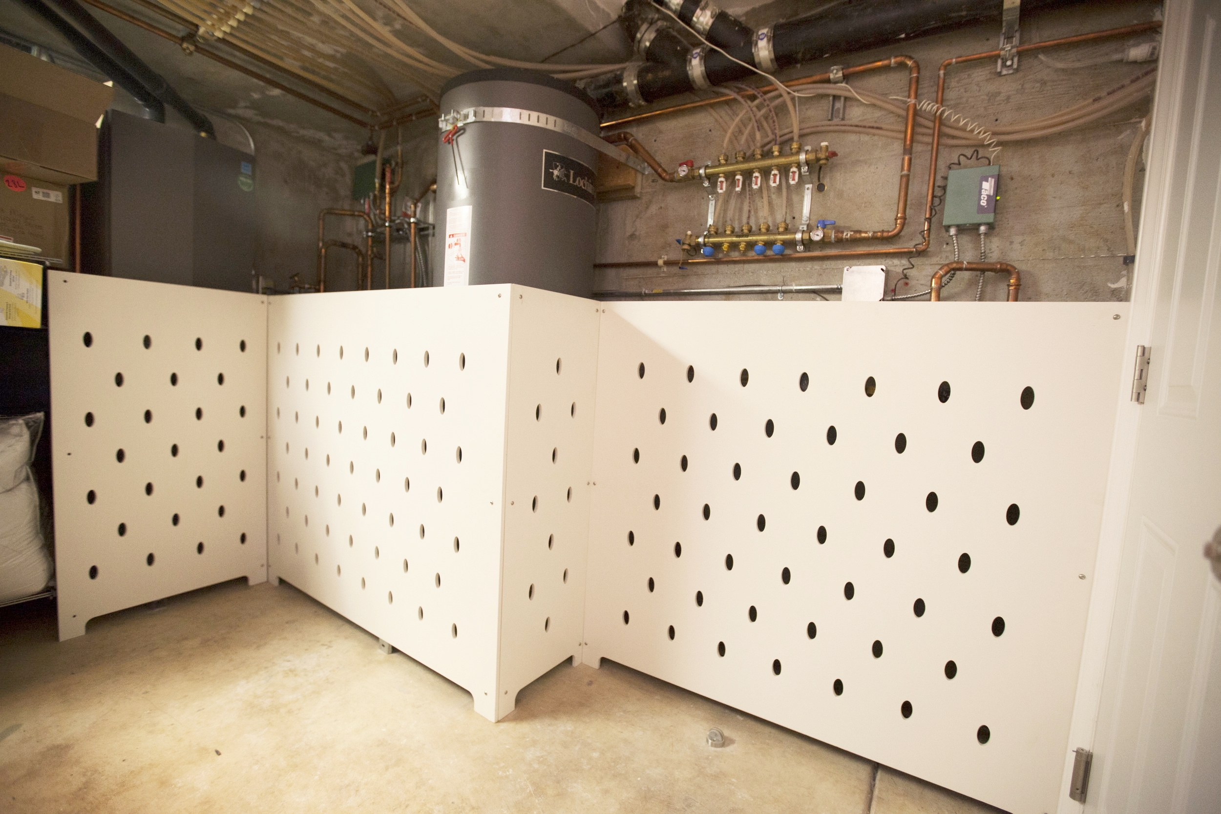 Water heater & pipe screens were designed by us; now the basement is safe for the young ones and more pleasing to the eye!