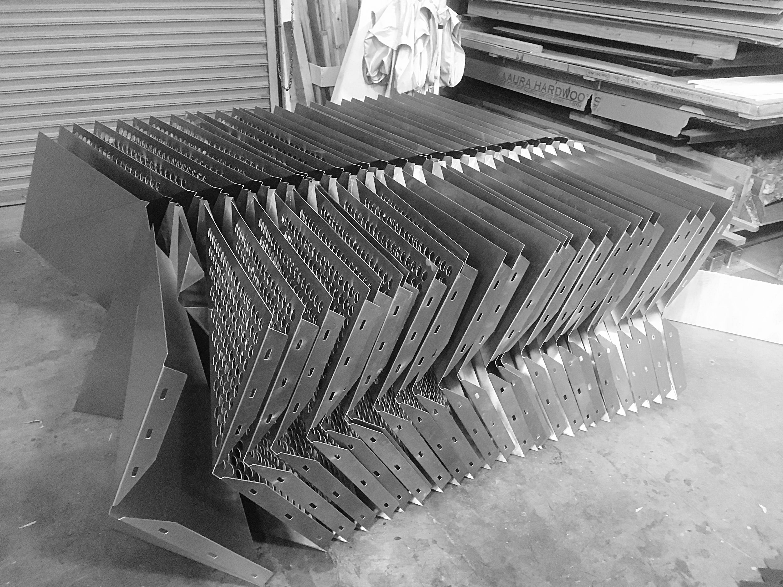  A stack of panels waits to be sent to the powder-coaters. 