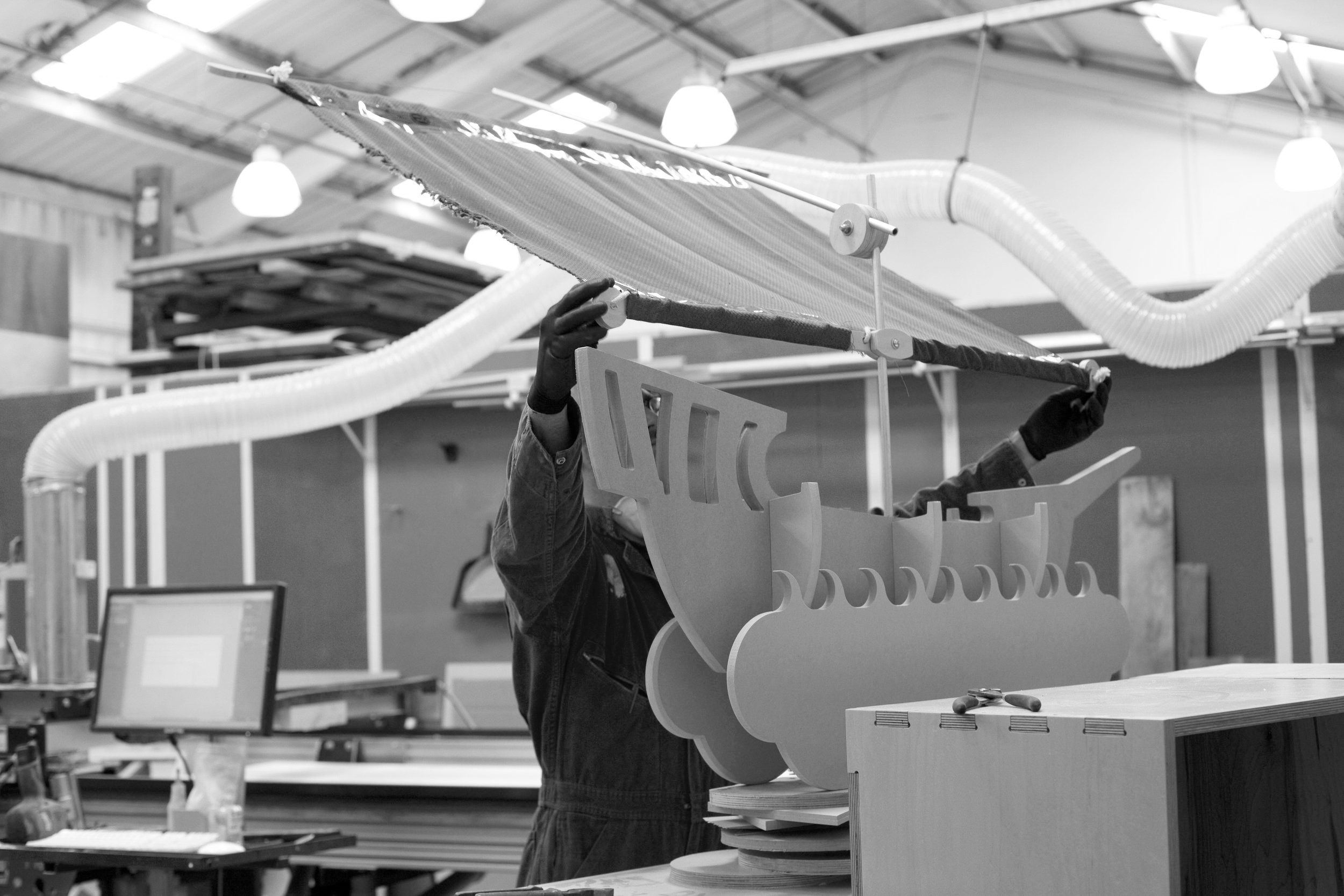 The ship sails receive their final fine tuning of hardware assembly before they are approved for shipping.