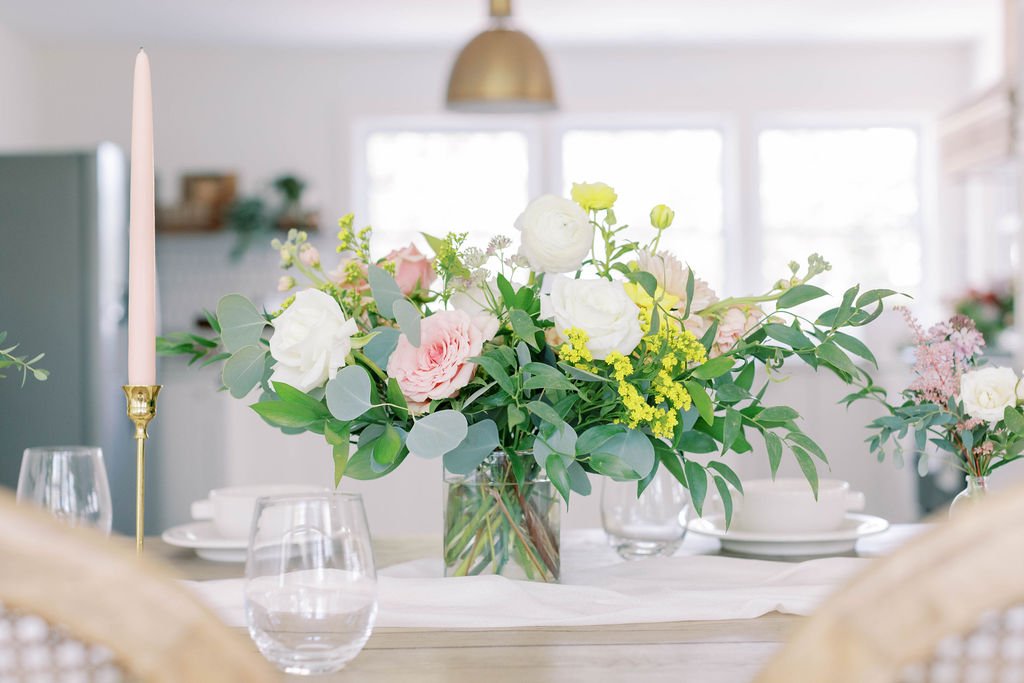 Large vase arrangement with bud vases