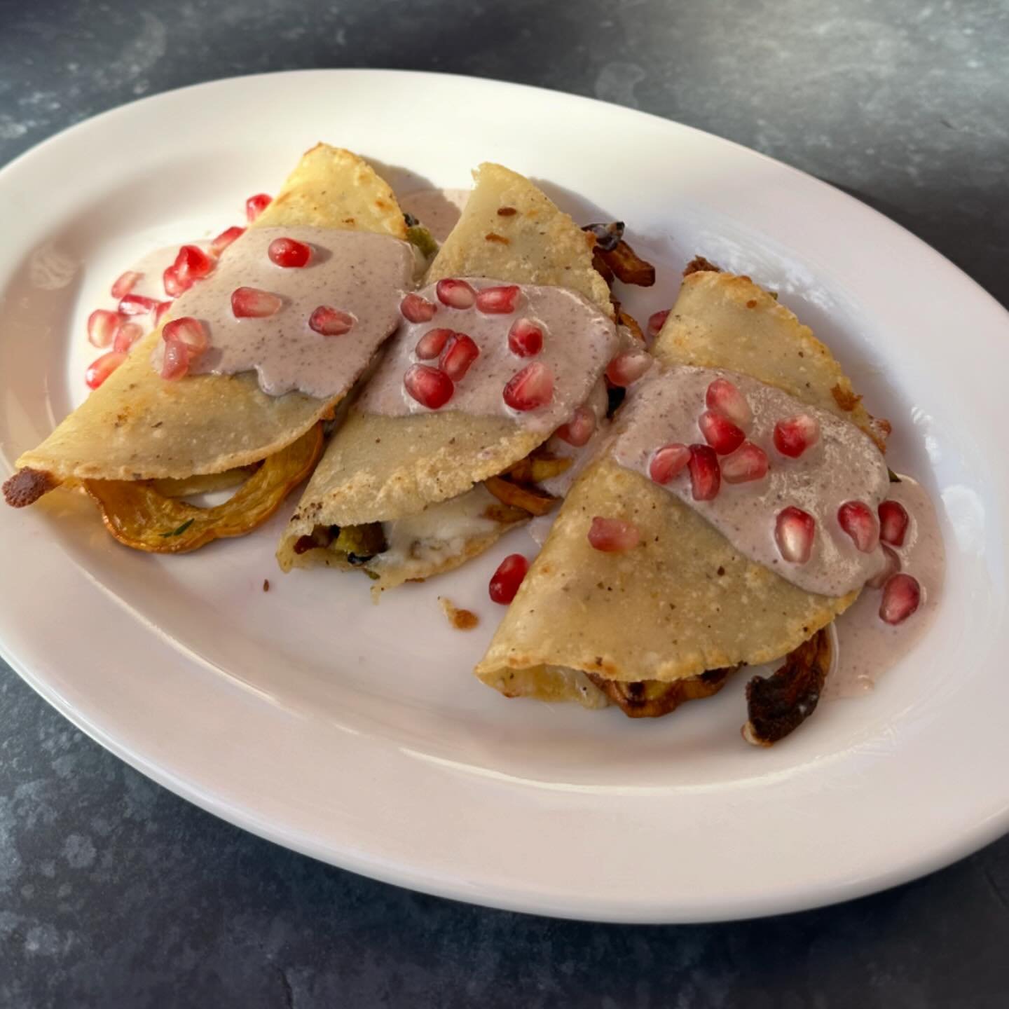 It&rsquo;s that time of year again &hellip;Quesadillas en Nogada is back! 
Delicata squash, rajas, and cheese filled tortillas with a toasted pecan cream sauce, finished with pomegranate seeds.