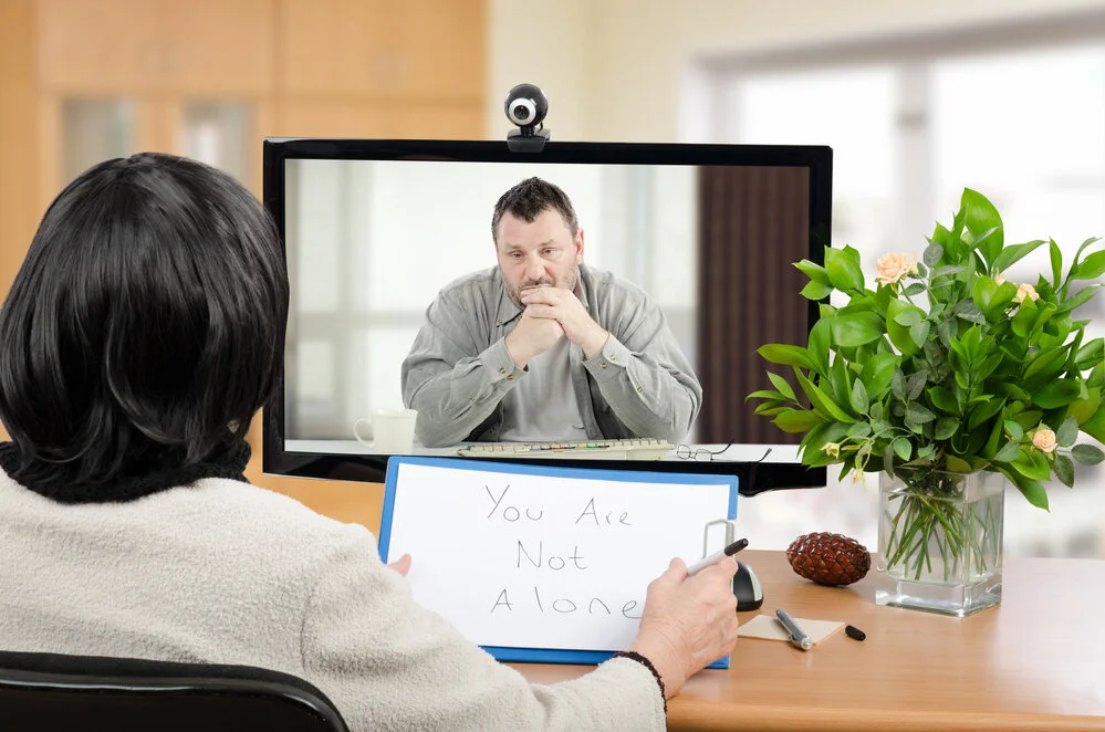 telehealth therapist with male.jpg