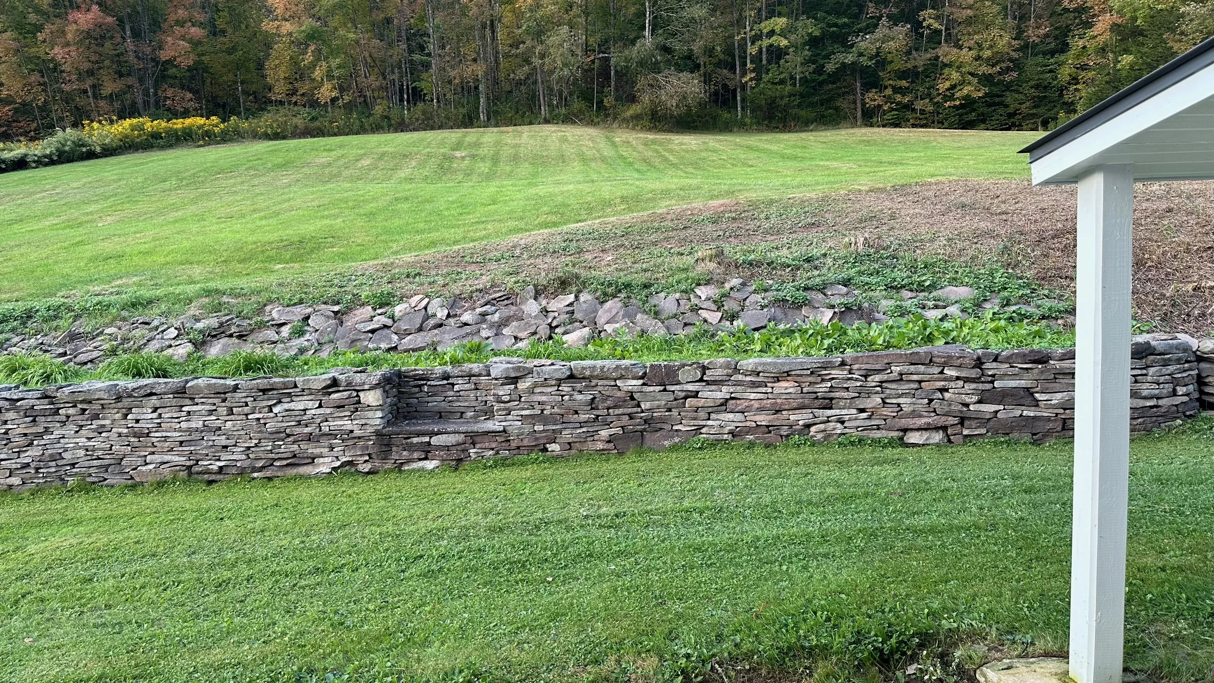 56 stonewall behind house.jpeg