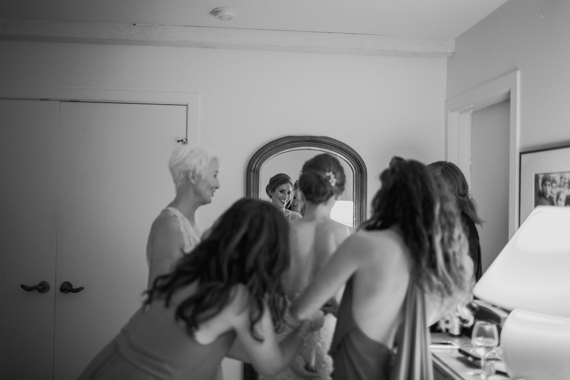 bride getting in her wedding dress