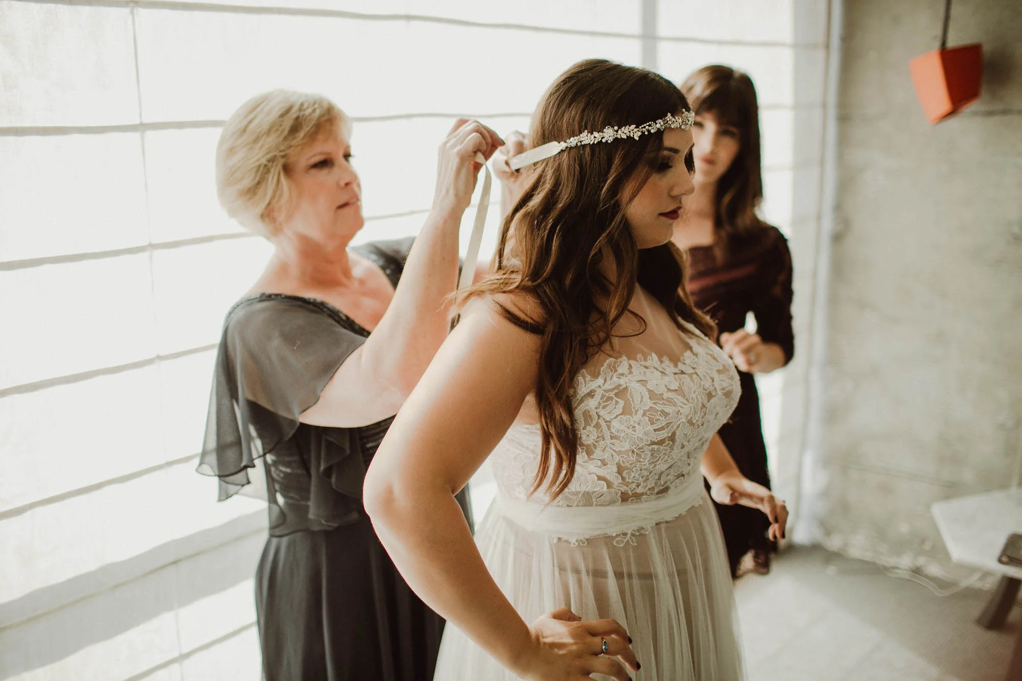 putting on wedding dress