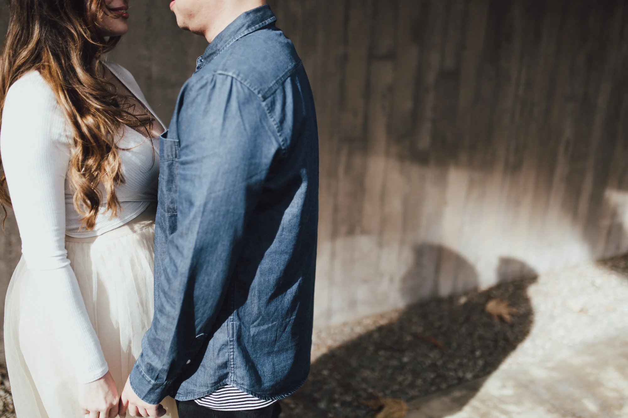 sunny engagement photo in downtown with cool shadows