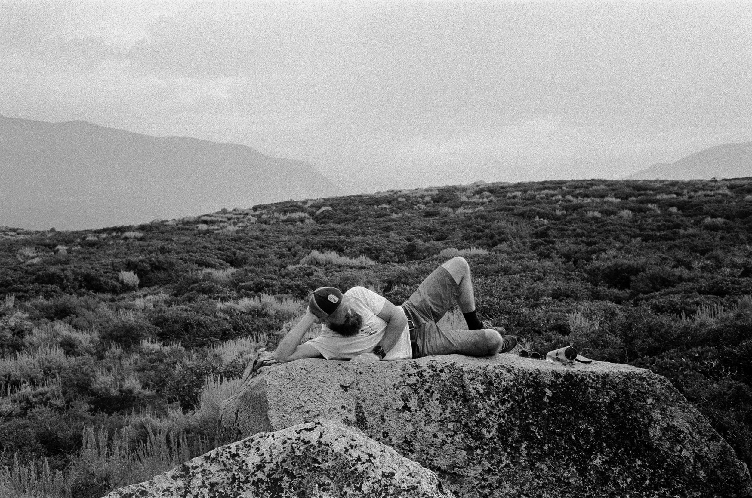 trevor lounging in between bouldering attempts