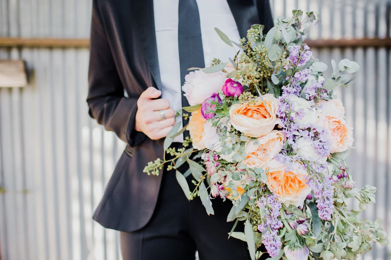 bride in tux with cascading bouquet #lrqcfloral #gaywedding