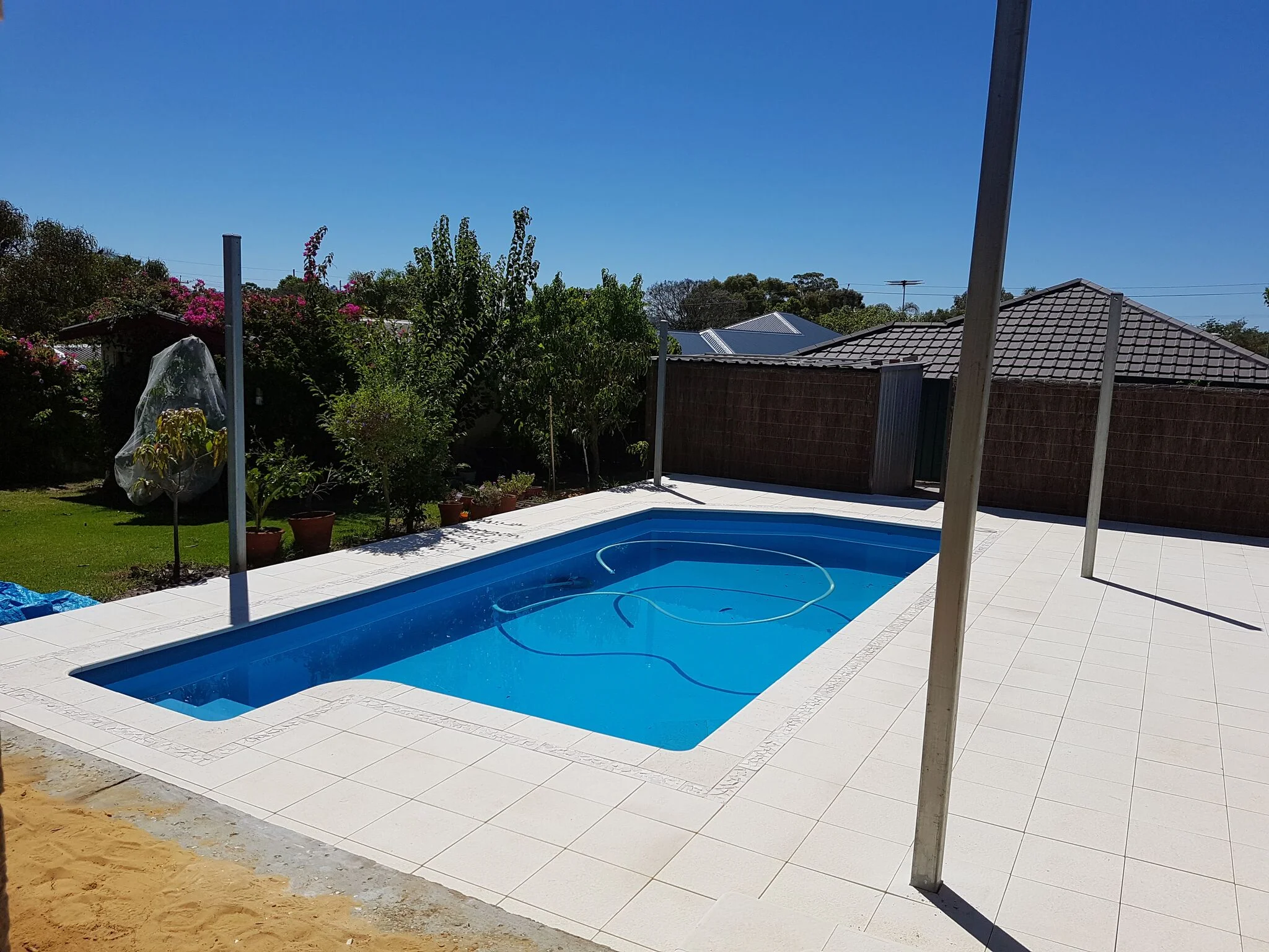 After: New paving resulted in a fresh open look to the pool area. Read our Review.