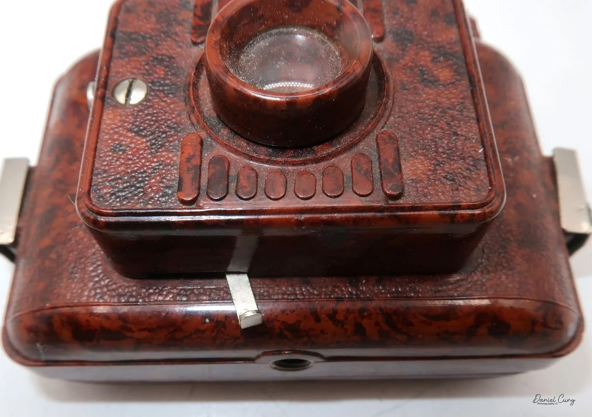 Shutter release under the lens