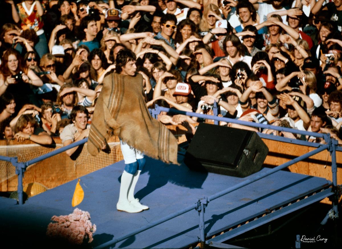 MicK Jagger in front of a large crowd.