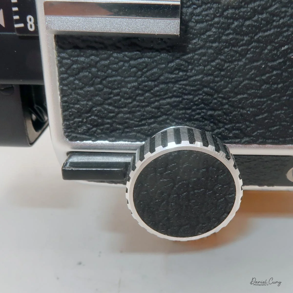 Locking knob on camera's side