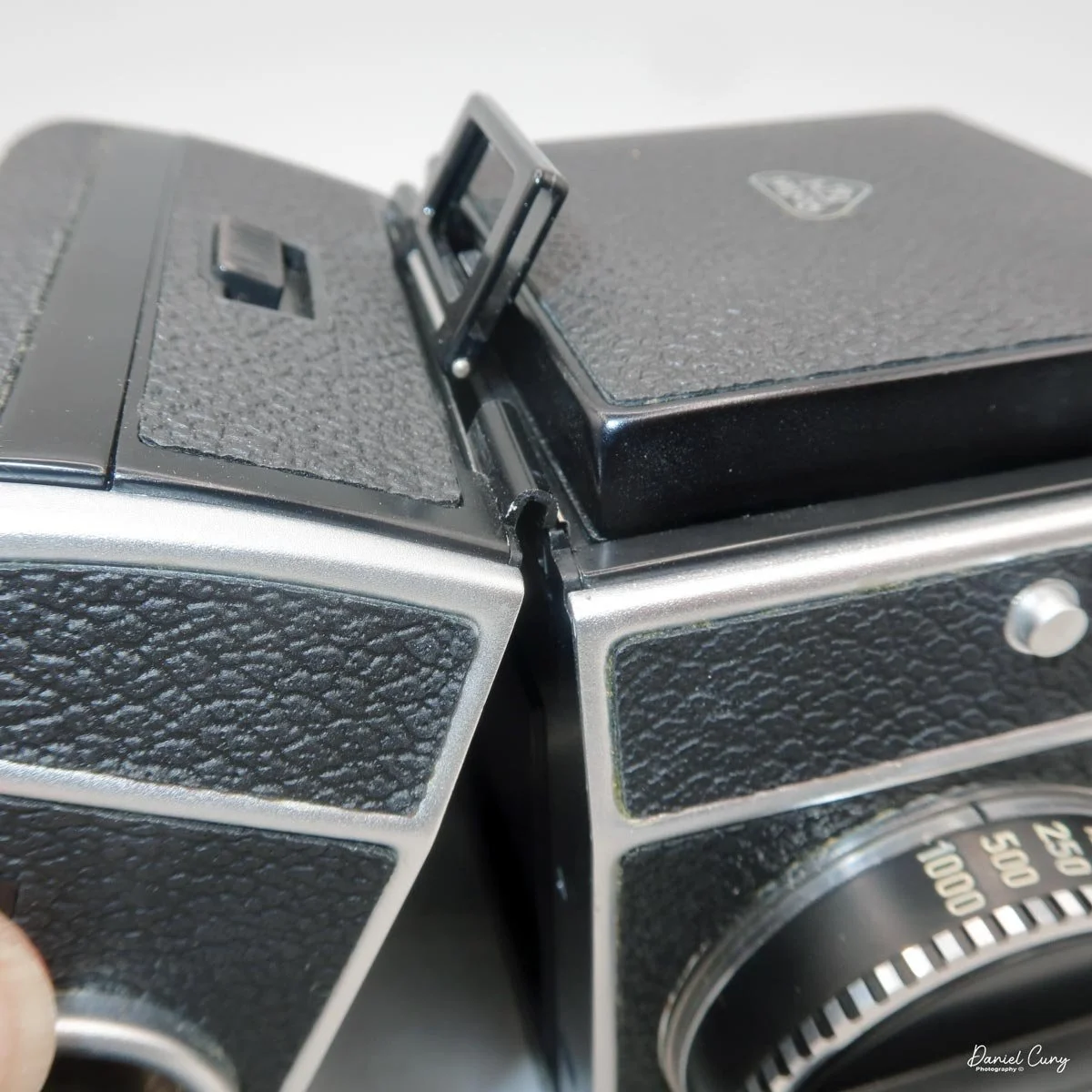 Clip on top to put film back onto camera body