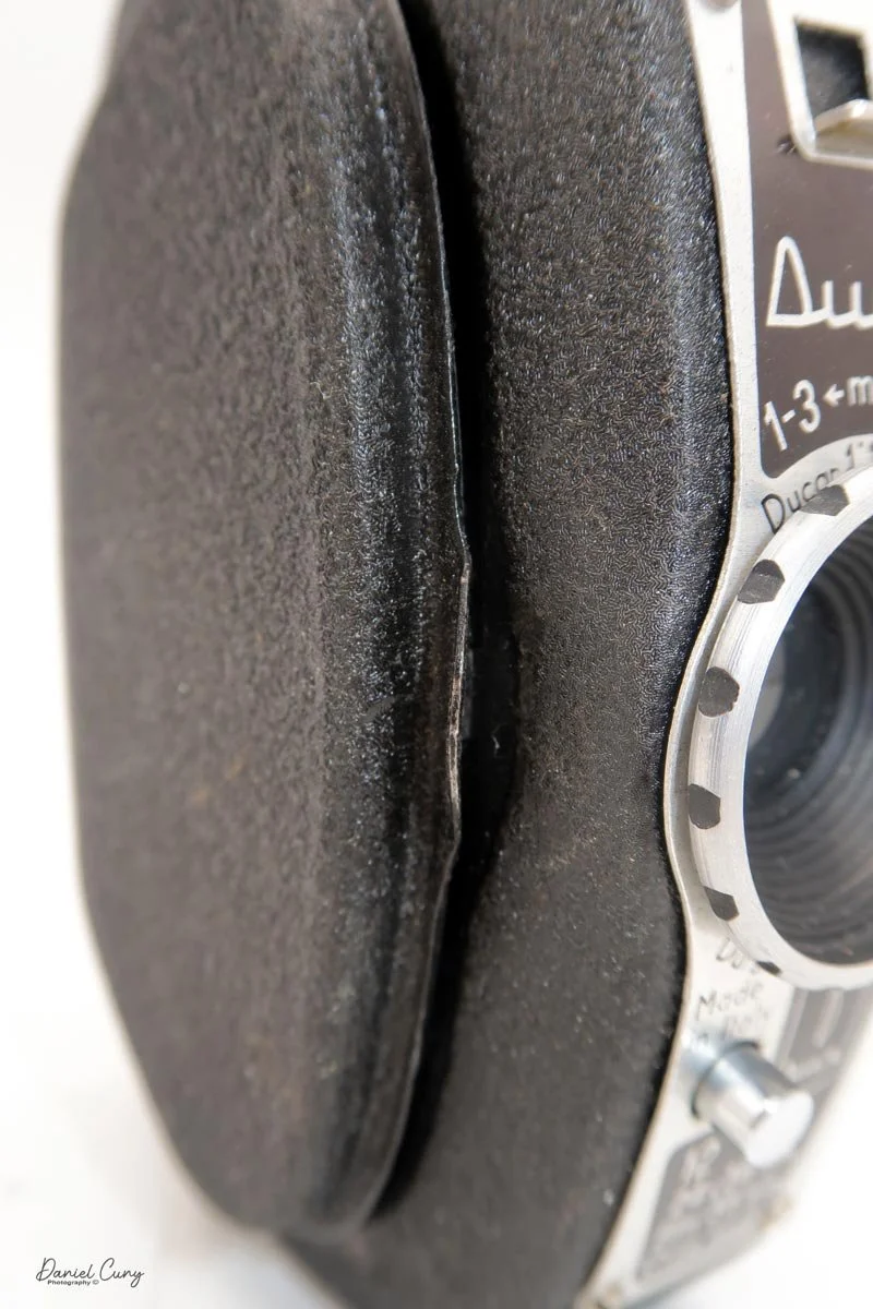 Curled lip on the side to open film door