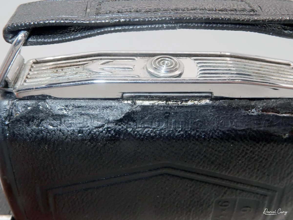 Sliding lever to open the film door.