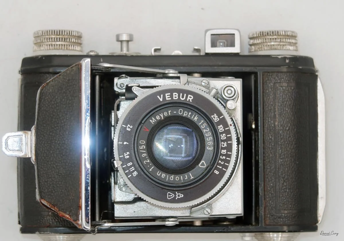 Camera opened showing shutter &amp; lens
