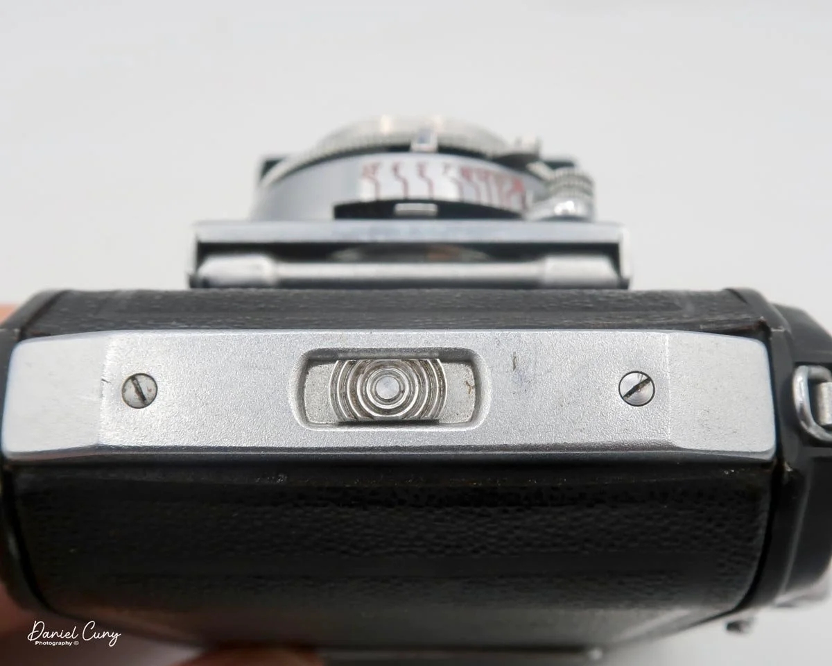 Button to open film door.