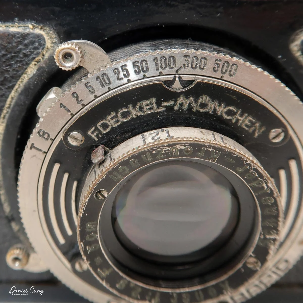 Shutter cocking lever, shutter speeds and focus indicator.