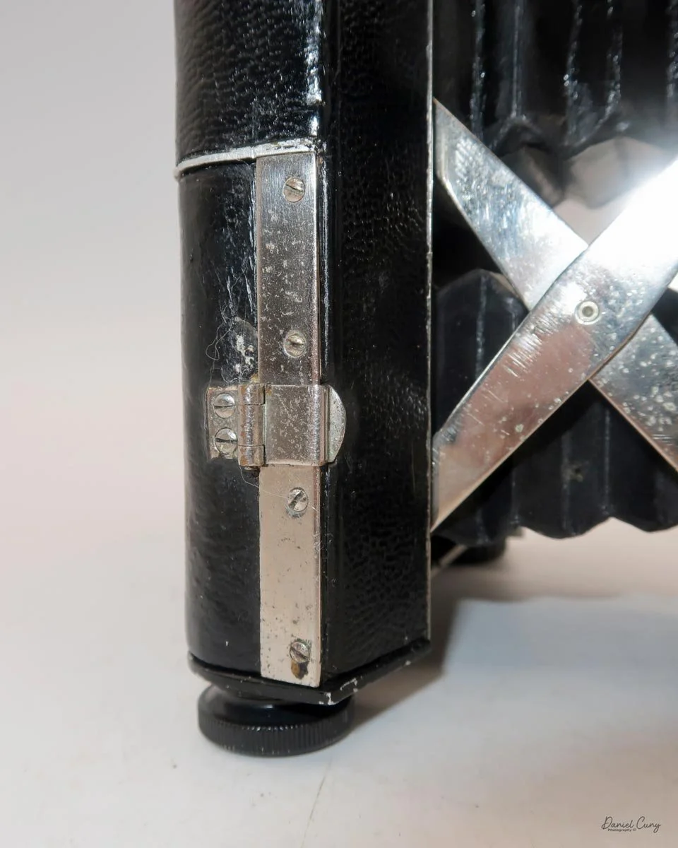 Flip back hook to open the film door.