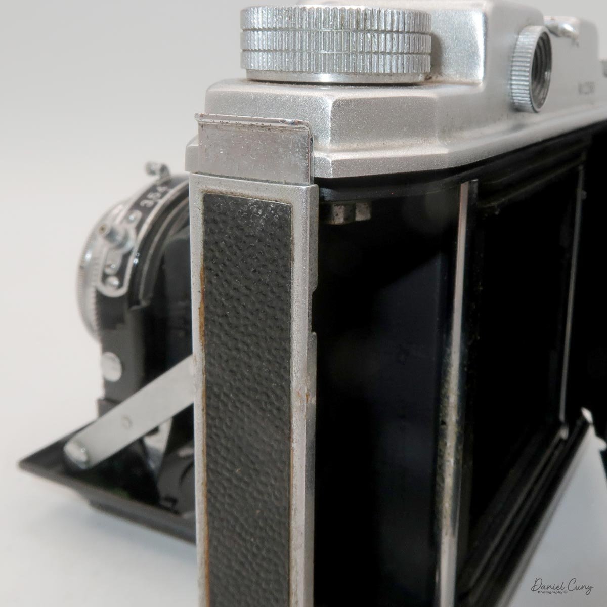 Lever to open film door.