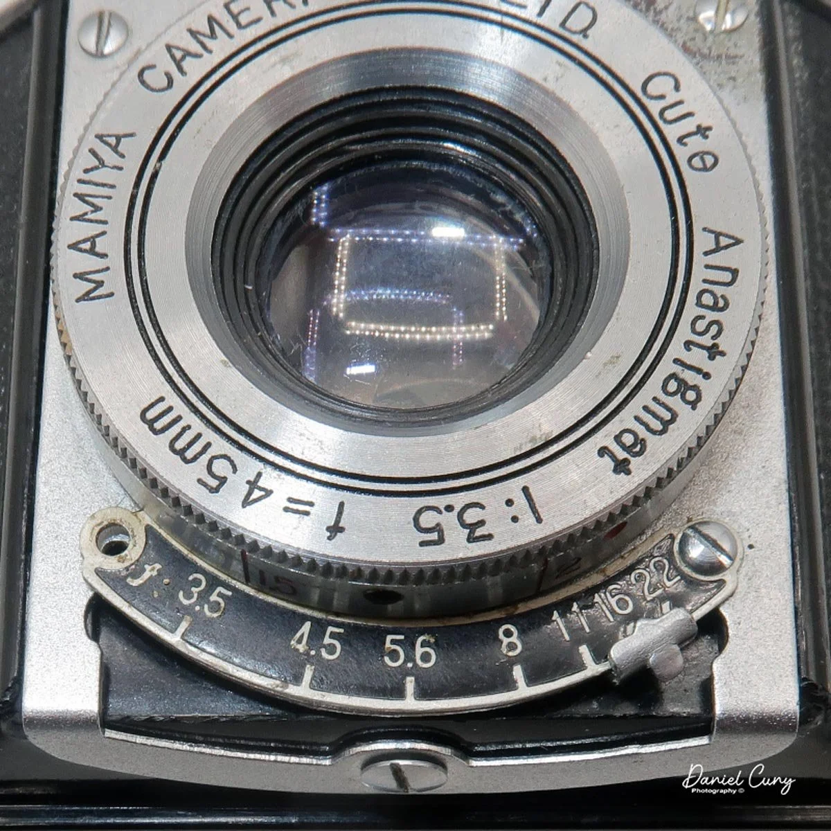 Aperture setting under the lens.