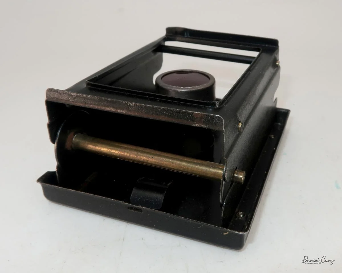Thread film through slots on film back.