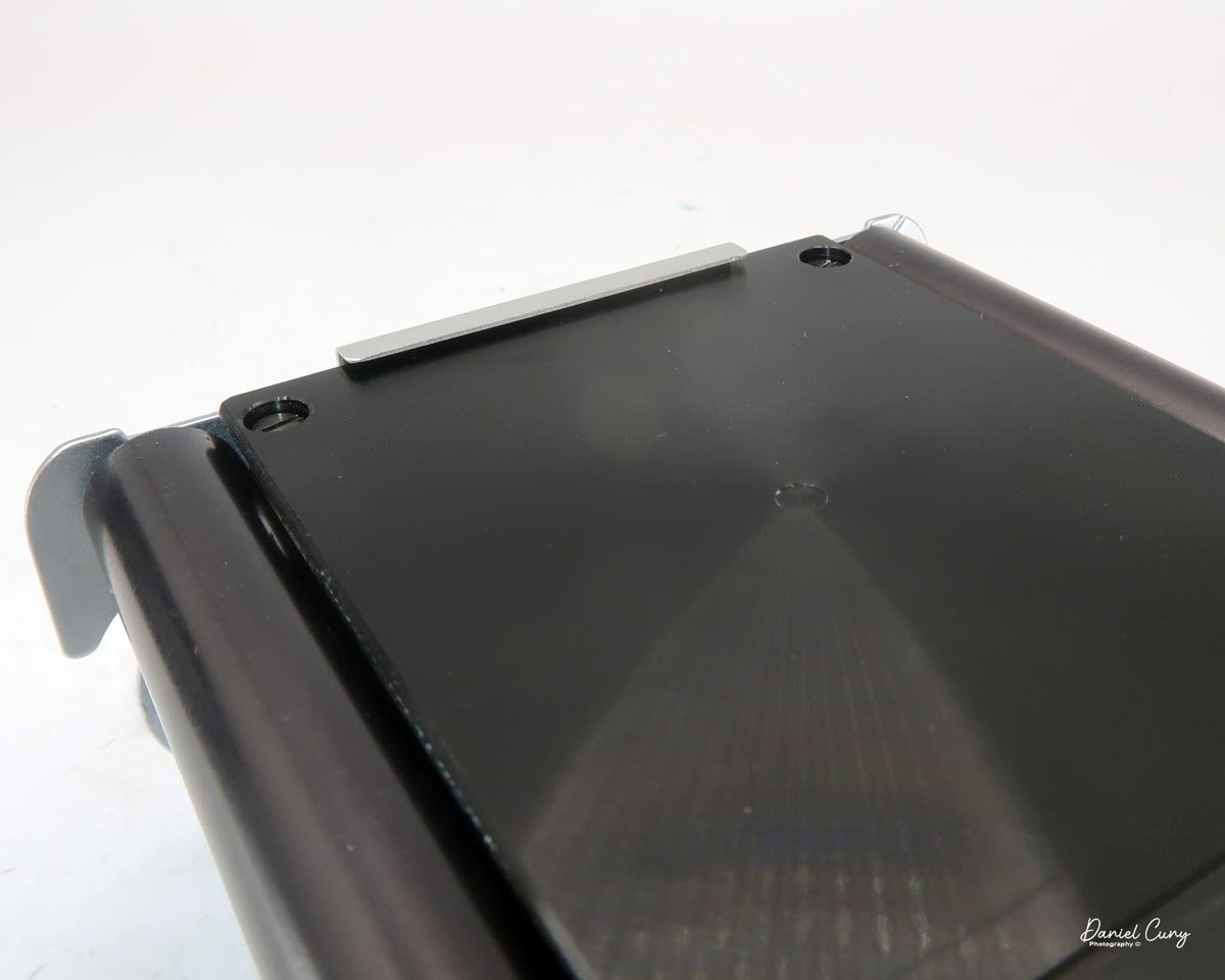 Make sure film slides under the lip on side.