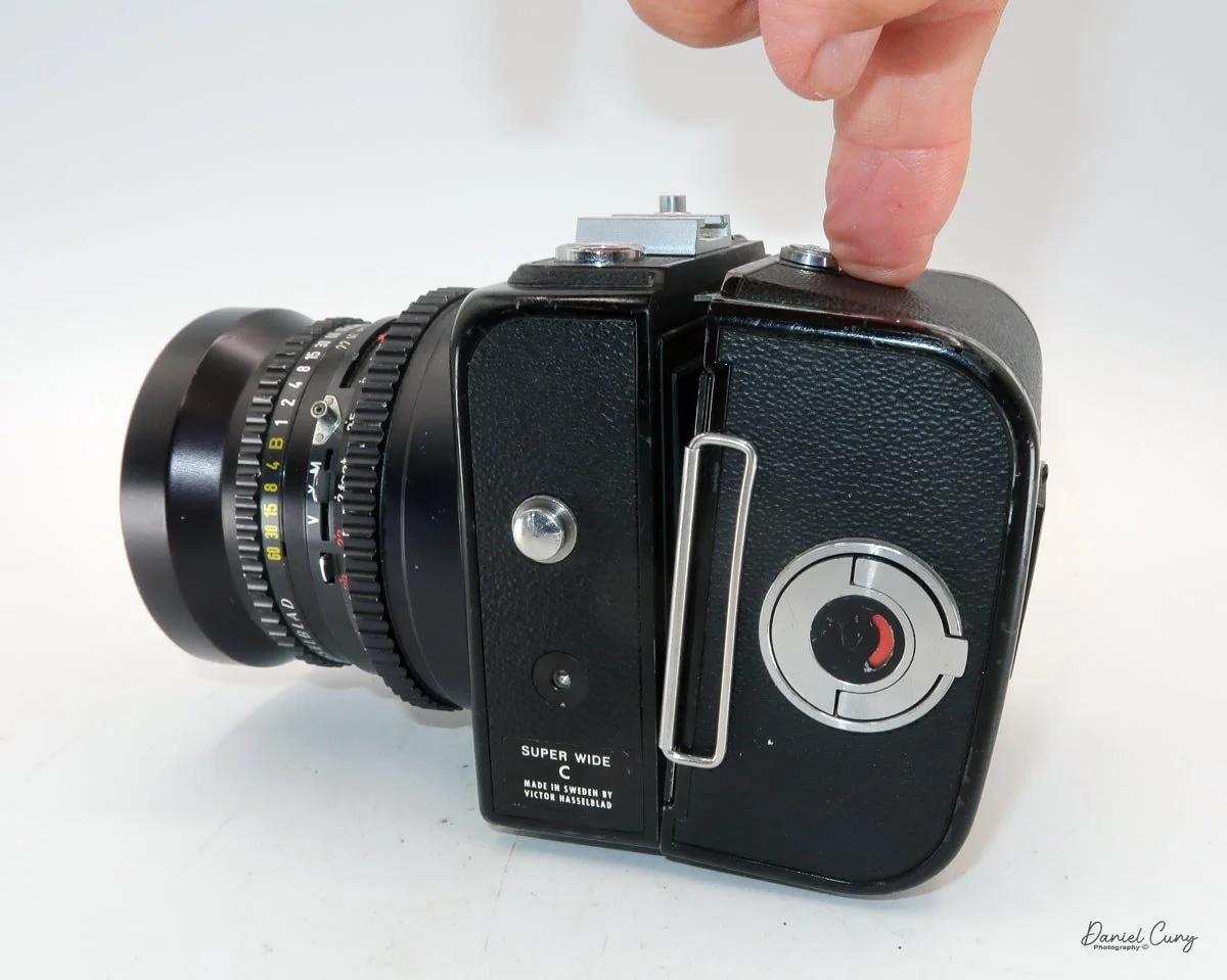 Attach film back onto camera body.
