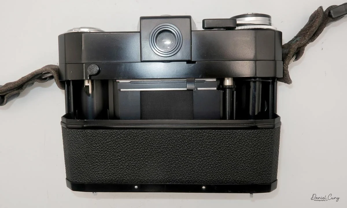 Slide off the camera back to load film
