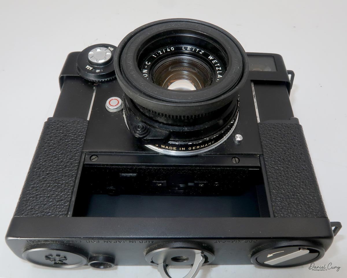 Attach film door onto camera body and lock it.