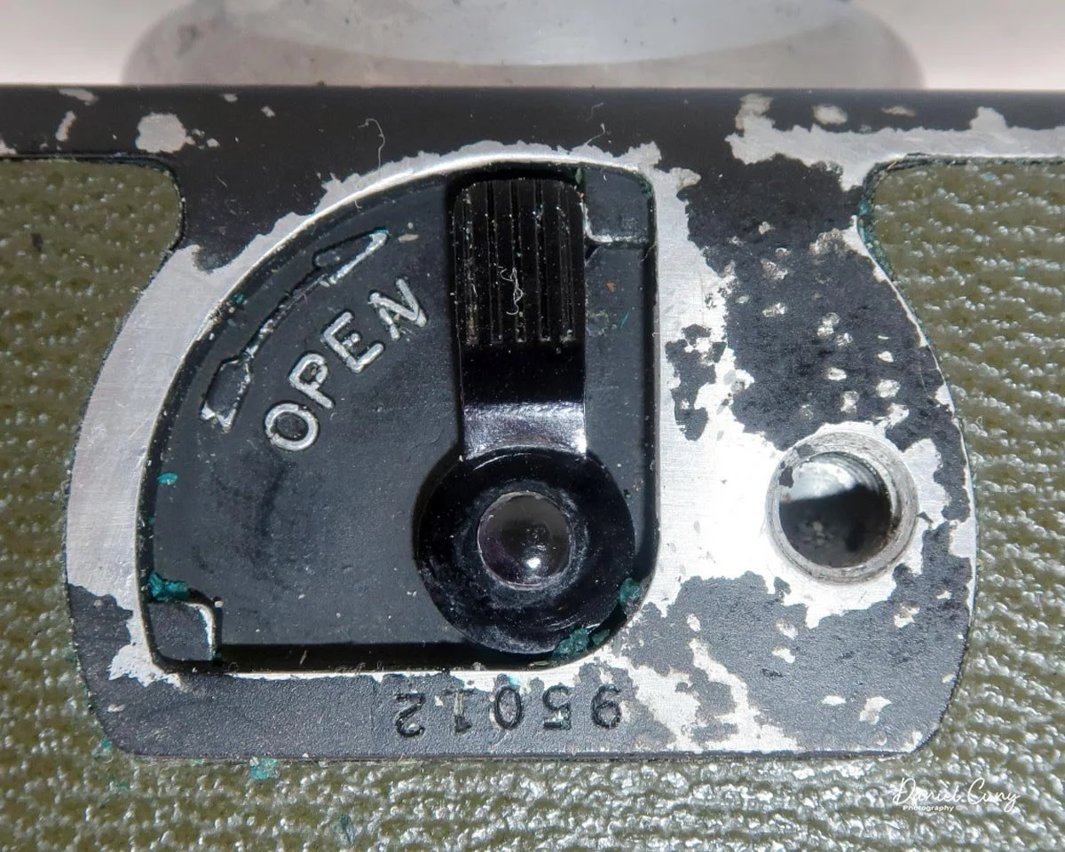 Latch to open film door.