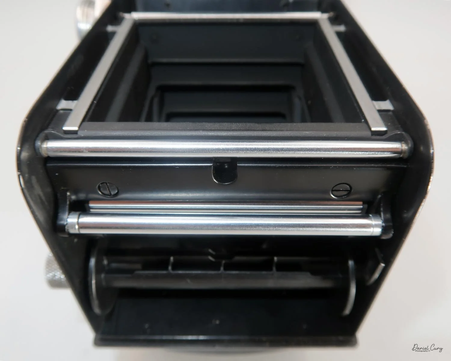 Slide film leader under the lower bar, then over the film plane