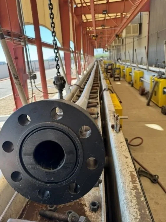 Copper State Rubber Decoking Hose flanged coupling at manufacturing facility.