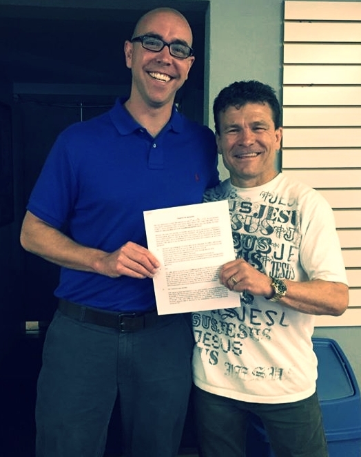 Pastor Brent with Troy Dorsey and the signed lease agreement for our church to meet weekly in the karate studio.