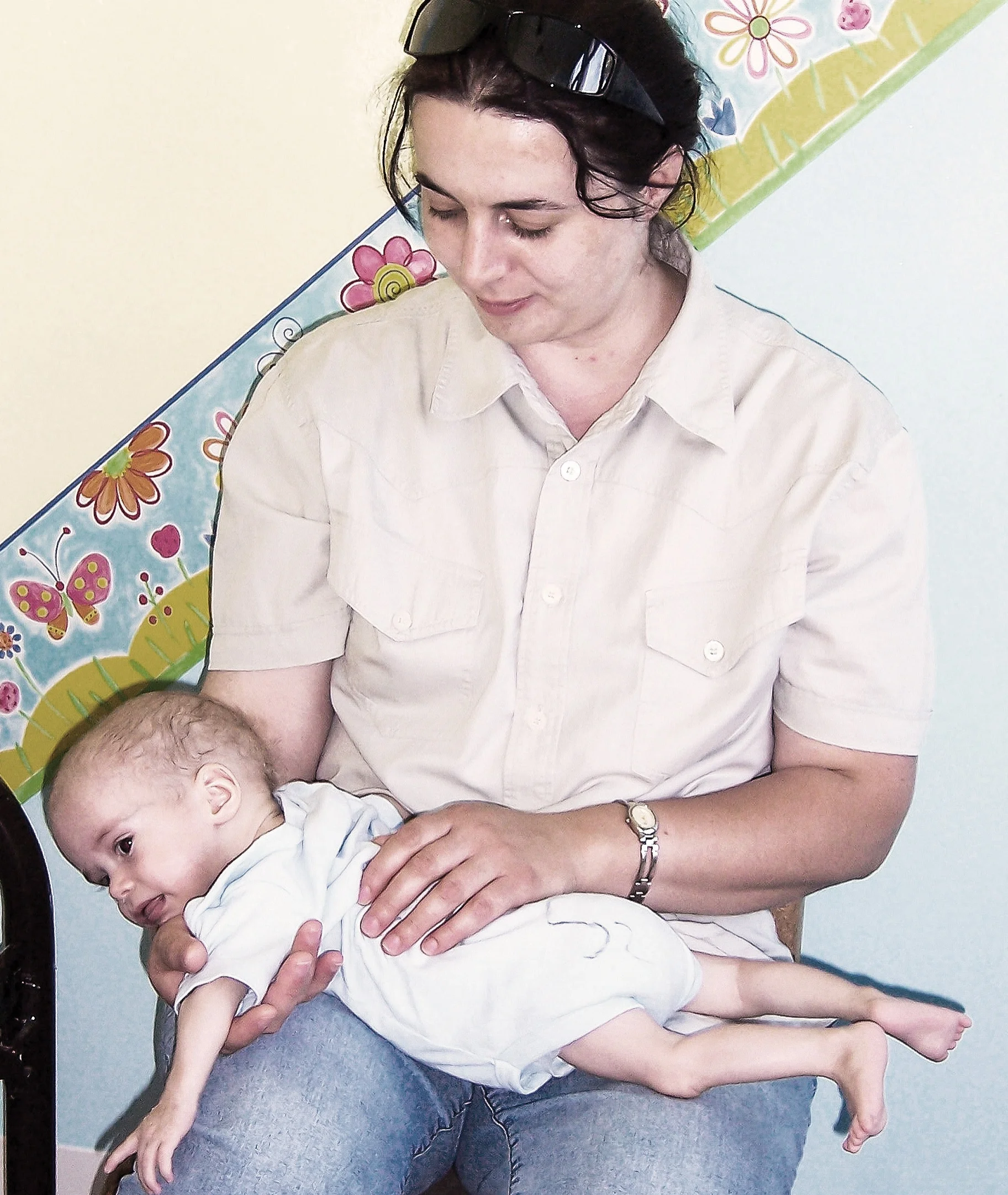 THEN: Corina with an abandoned baby at the hospital in 2005