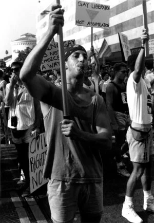 Outraged by Gov. Pete Wilson’s veto of a gay rights bill that would have outlawed job descrimination on the basis of sexual orientation. Timm constructed a banner the night before a protest march and unexpectedly found himself in the front of a sea of thousands who marched down Wilshire Blvd.