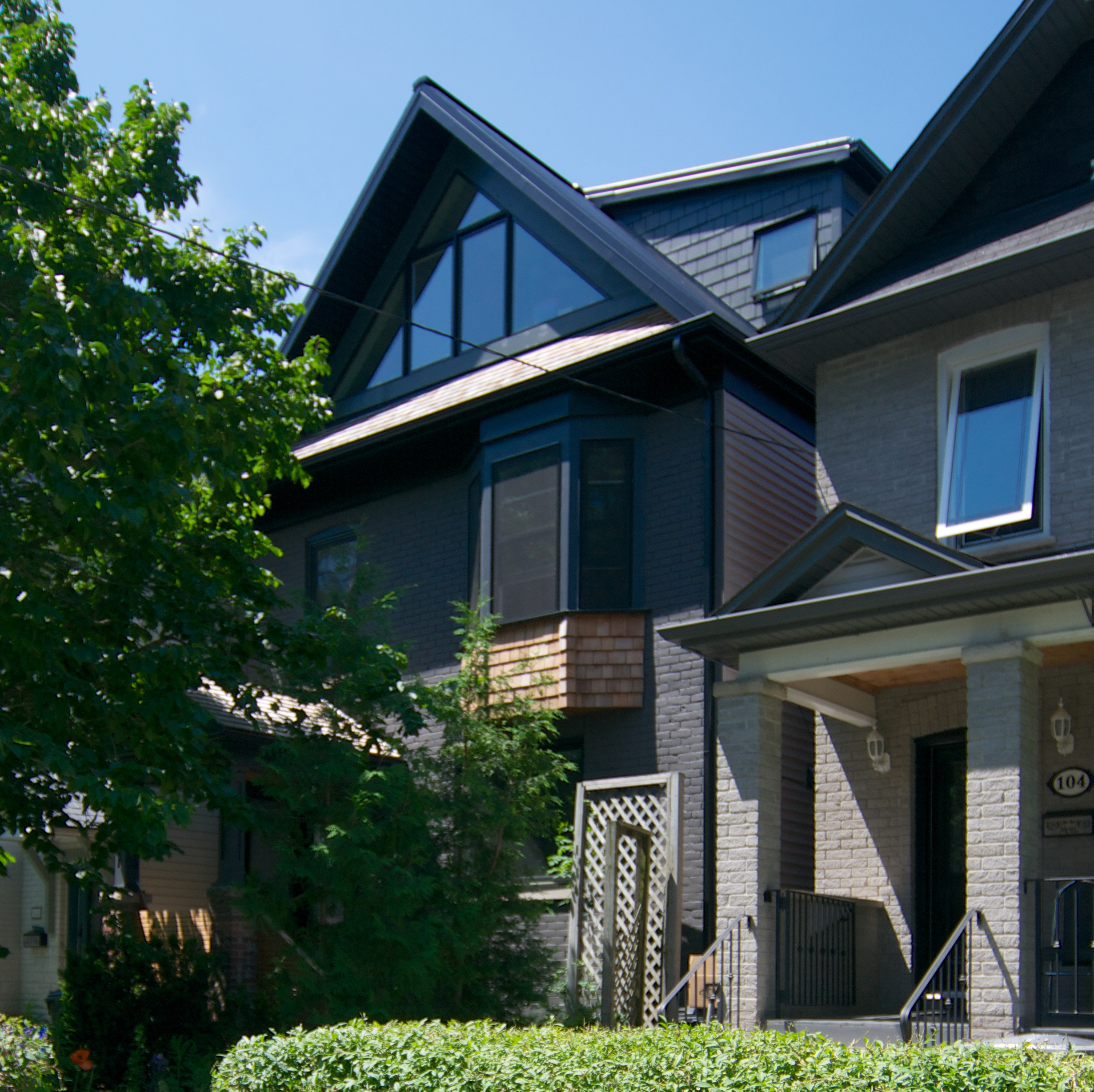 Danforth Home Sustainable Renovation + Addition This renovation project near The Danforth has allowed the family to maintain their familiar surroundings and neighbourhood connections, while updating their existing home. The ground floor was opened up to create a large room with a connected kitchen, dining room, and living area opening out to a rear garden. The back of the house features a large sliding panoramic door to access the rear deck. With an open floor plan inside, it is possible for all rooms to be used separately, while maintaining connections throughout. The second floor features new bathrooms and renovated bedrooms, with new fixtures and finishes throughout. The third floor is accessed from above the existing stair, adding dormers on both sides of the house to provide additional headroom. While previously a large open space with low headroom, it now features new full-height bedroom, bathroom, and study. A durable, self-venting Galvalume metal roof helps lower the cooling load of the home in the summer time. Three small, wall-mounted air-source heat-pump units keep the house cool. These units have individual thermostats on each floor, allowing for fine-tuning to improve efficiency. In-floor radiant heat is featured on the ground floor, with hot-water radiators on the second and third floors. These are paired with a high-efficiency Heat Recovery Ventilator (HRV) to provide ventilation and fresh air to all spaces. All windows were replaced with well-sealed, aluminum-clad wood windows. Openings were made air-tight to reduce thermal loss through windows and air leakage through any gaps, including the large sliding panoramic door on the ground floor. Approvals included Committee of Adjustment and Urban Forestry.