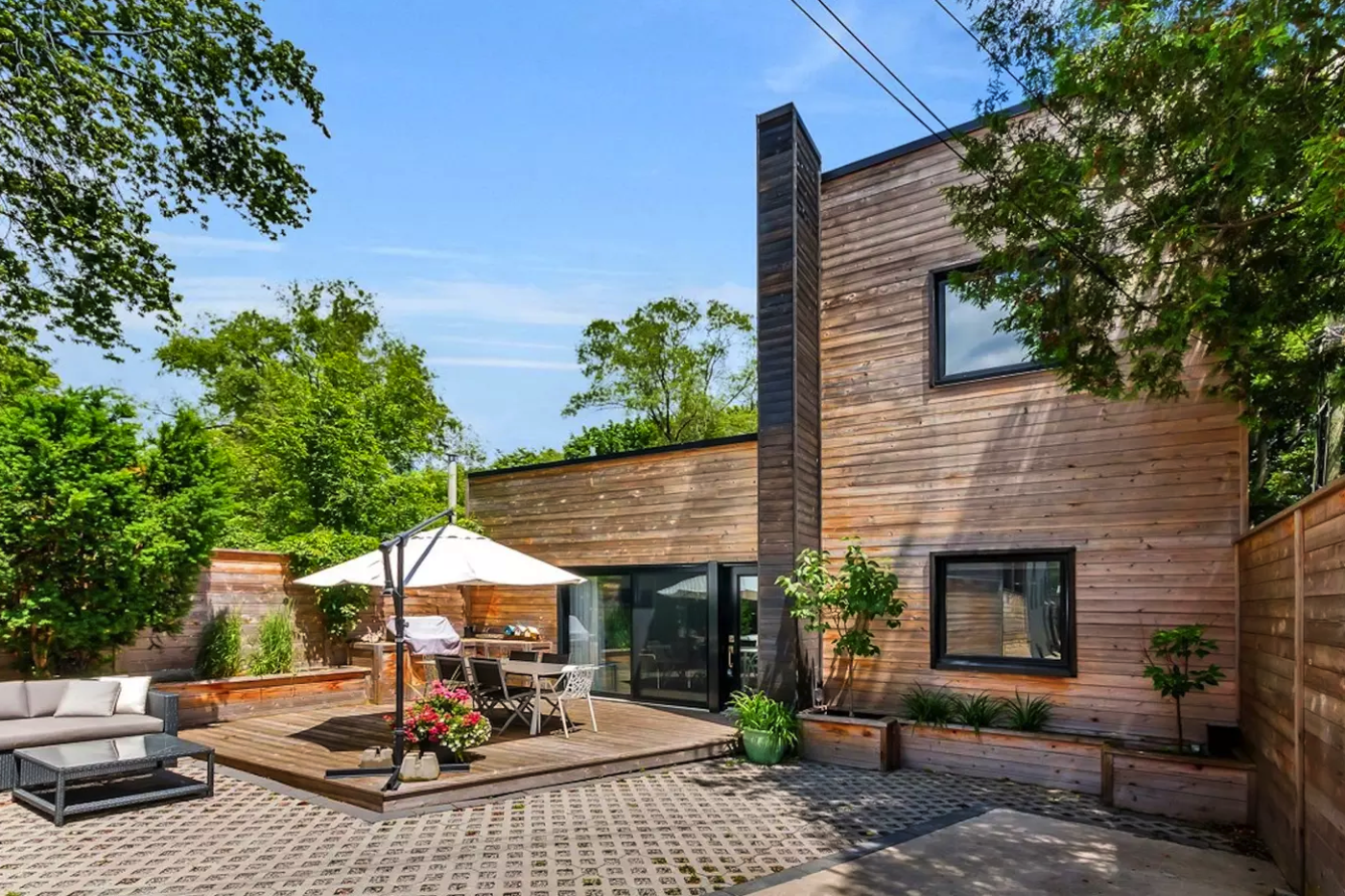 Jones Avenue Laneway House Sustainable Laneway House Renovation + Addition Sustainable transformed an illegal, one-storey apartment (originally a converted garage) into a fully-legal, classically-proportioned, and visually stunning laneway house in Toronto’s east end Riverdale Pocket. The simple cedar deck boards that clad the feature-wall have been charred using a Japanese method known as shou-sugi-ban: a process of burning wood, dousing it, drying it, and then applying a coat of natural oil. The process renders the wood practically maintenance-free while adding resistance to fire and rot. A new concrete floor was poured with an in-floor radiant heating system. On sunny winter days, sunlight entering the home’s large windows warms the exposed polished concrete floor, keeping the space warm and comfortable while reducing the need for heating energy. Although small and tucked away, this home makes a big contribution to the city – not the least of which was positive influence on the City’s adoption of bylaws permitting the construction of Laneway Suites. Sustainable’s Jones Avenue Laneway House demonstrates that challenging sites deserve thoughtful designs, proving that laneway houses can add to, rather than detract from, the urban fabric.