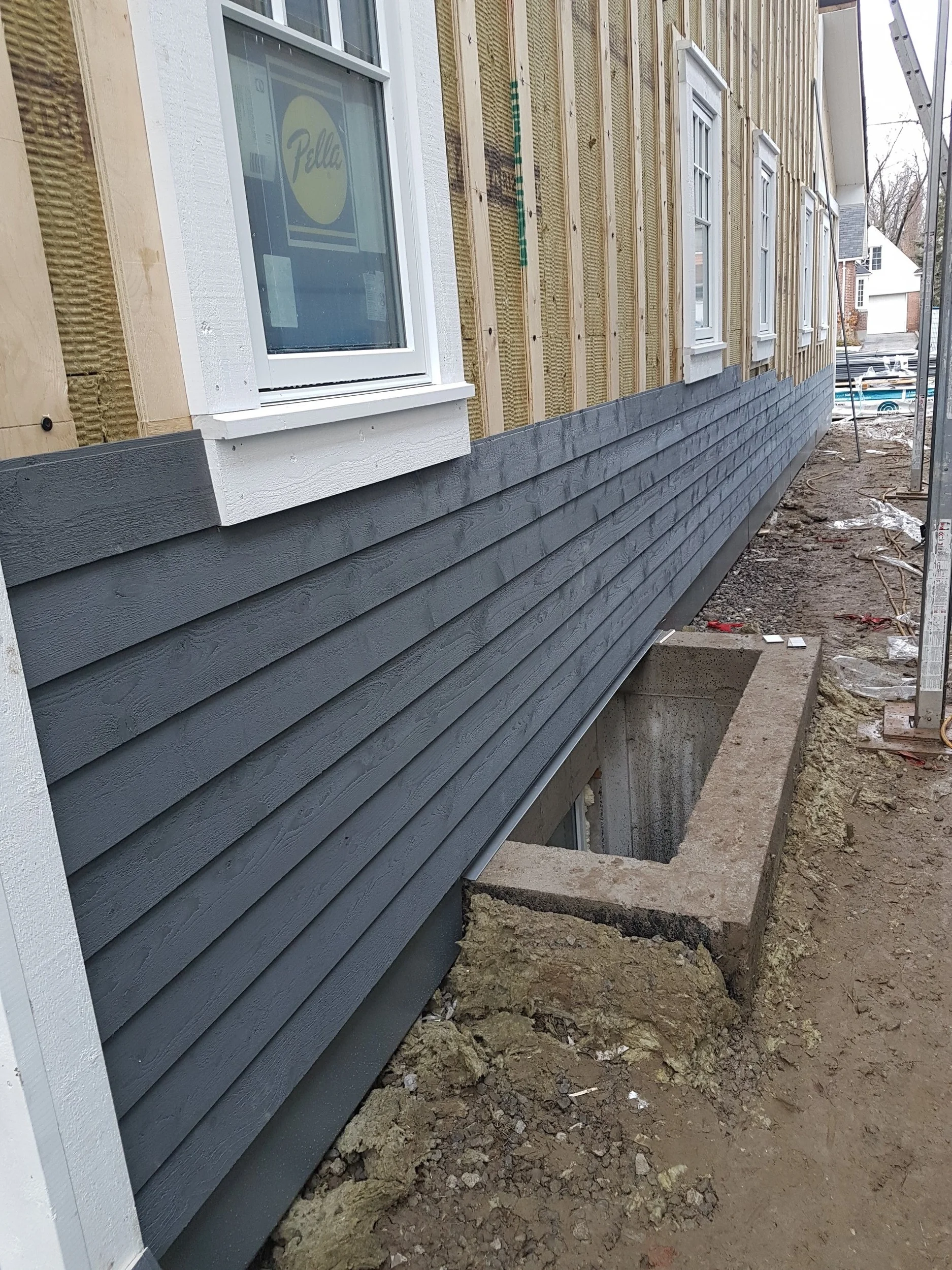 Wood siding over exterior mineral wool insulation.