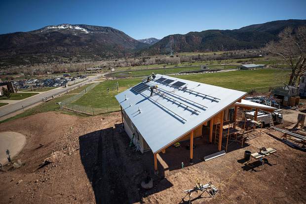 Sunsense Solar employees Kevin Lundy, Matt Greenlund and Cole Alexander install solar panels on the roof for the Habitat for Humanity Basalt Vista netzero project on April 19. Anna Stonehouse/The Aspen Times